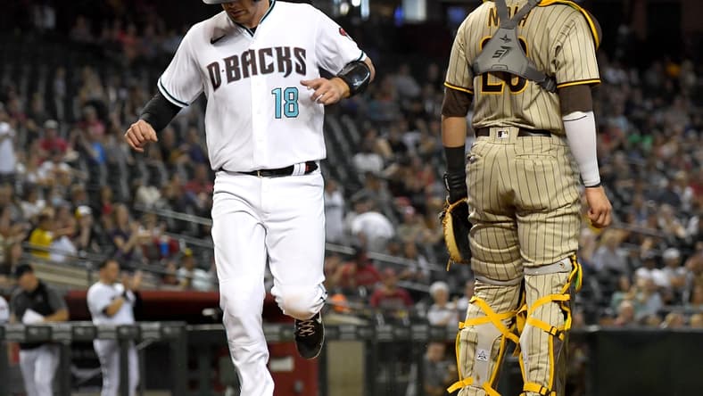 Aug 13, 2021; Phoenix, Arizona, USA; Arizona Diamondbacks catcher Carson Kelly (18) scores a run past San Diego Padres catcher Austin Nola (26) in the second inning of the game at Chase Field. Mandatory Credit: Jayne Kamin-Oncea-USA TODAY Sports