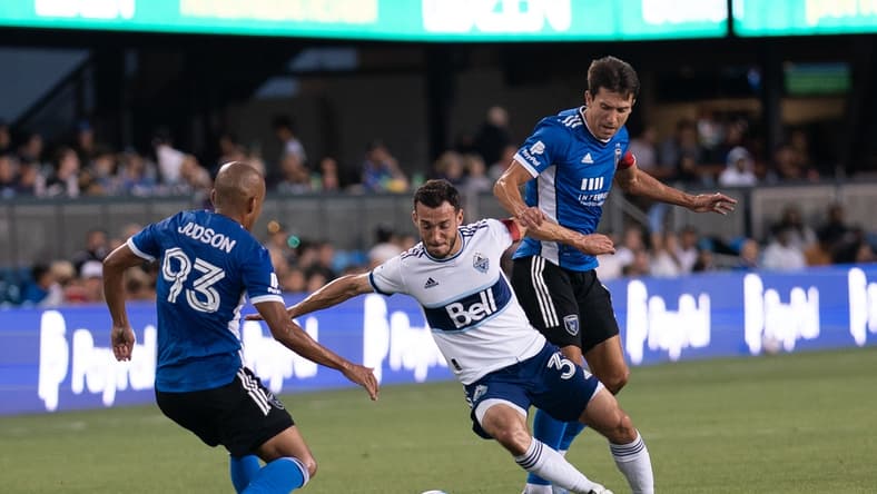 Aug 13, 2021; San Jose, California, USA; Vancouver Whitecaps midfielder Russell Teibert (31) fights for control of the ball against San Jose Earthquakes midfielder Judson (93) and defender Tanner Beason (15) during the first half at PayPal Park. Mandatory Credit: Stan Szeto-USA TODAY Sports