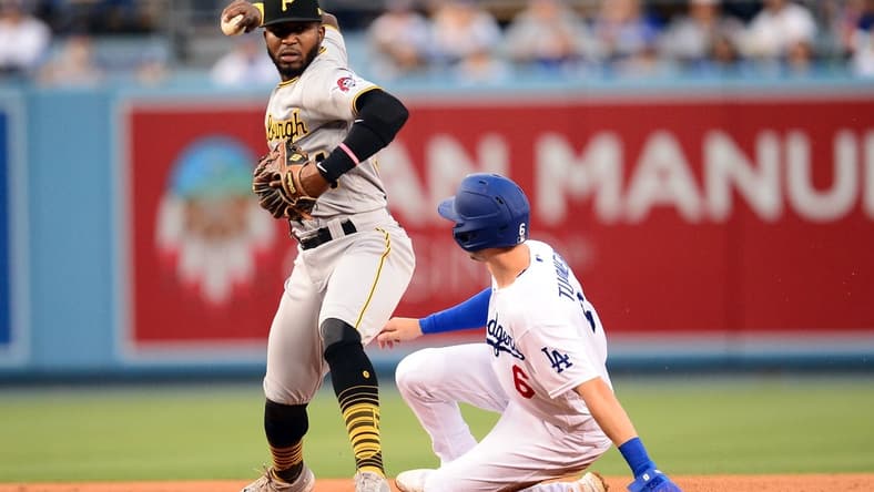 Aug 16, 2021; Los Angeles, California, USA; Los Angeles Dodgers shortstop Trea Turner (6) is out at second as Pittsburgh Pirates second baseman Rodolfo Castro (64) throws to first for the out against first baseman Albert Pujols (55) during the first inning at Dodger Stadium. Mandatory Credit: Gary A. Vasquez-USA TODAY Sports