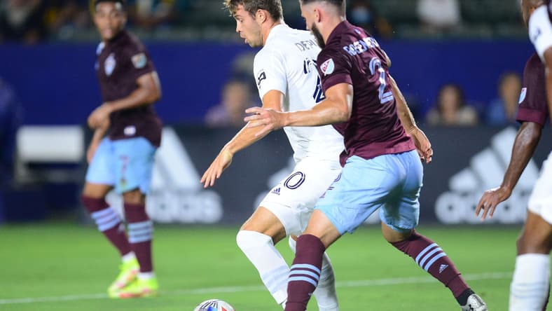 Aug 17, 2021; Carson, California, USA; Los Angeles Galaxy forward Nick DePuy (20) controls the ball against Colorado Rapids defender Keegan Rosenberry (2) during the first half at Dignity Health Sports Park. Mandatory Credit: Gary A. Vasquez-USA TODAY Sports