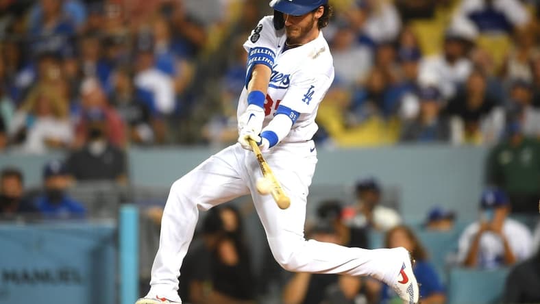 Aug 17, 2021; Los Angeles, California, USA;  Los Angeles Dodgers center fielder Cody Bellinger (35) hits a double in the third inning against the Pittsburgh Pirates at Dodger Stadium. Mandatory Credit: Jayne Kamin-Oncea-USA TODAY Sports
