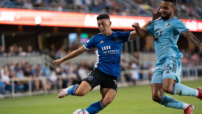 Aug 17, 2021; San Jose, California, USA; Minnesota United defender D.J. Taylor (26) attempts to defend against San Jose Earthquakes forward Cristian Espinoza (10) during the first half at PayPal Park. Mandatory Credit: Stan Szeto-USA TODAY Sports