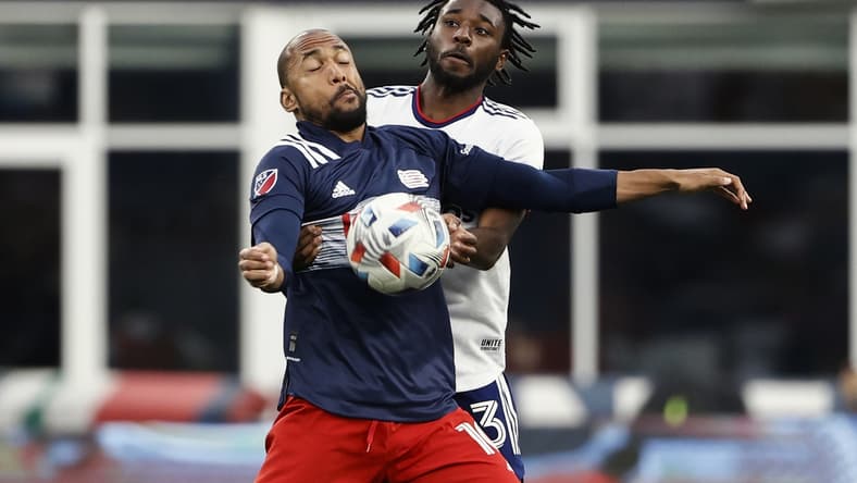 Aug 18, 2021; Foxborough, Massachusetts, USA; New England Revolution forward Teal Bunbury (10) tries to keep D.C. United defender Chris Odoi-Atsem (3) from the ball during the first half at Gillette Stadium. Mandatory Credit: Winslow Townson-USA TODAY Sports