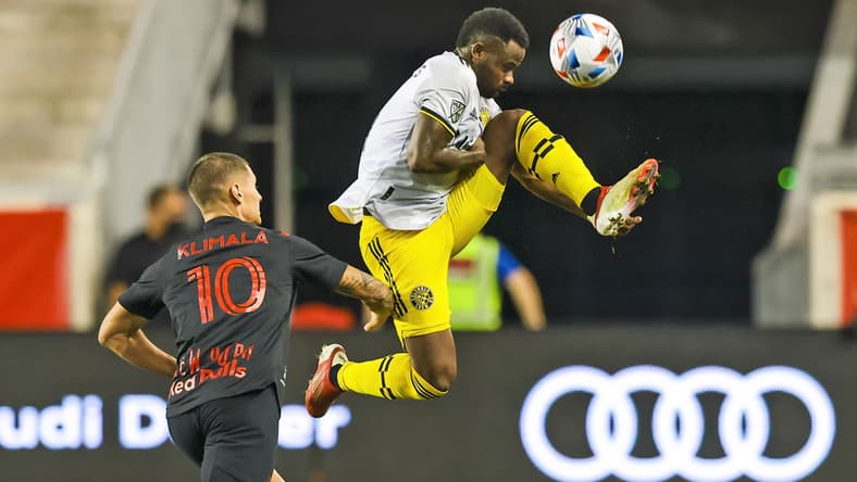 Aug 18, 2021; Harrison, New Jersey, USA; Columbus Crew midfielder Kevin Molino (9) tries to controls the ball as New York Red Bulls forward Patryk Klimala (10) defends during the first half at Red Bull Arena. Mandatory Credit: Vincent Carchietta-USA TODAY Sports