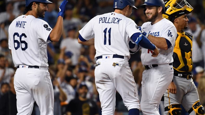 Aug 18, 2021; Los Angeles, California, USA; Los Angeles Dodgers first baseman Max Muncy (second from right) is congratulated by left fielder A.J. Pollock (11) and relief pitcher Mitch White (66) after hitting a three-run home run against the Pittsburgh Pirates during the fourth inning at Dodger Stadium. Mandatory Credit: Richard Mackson-USA TODAY Sports