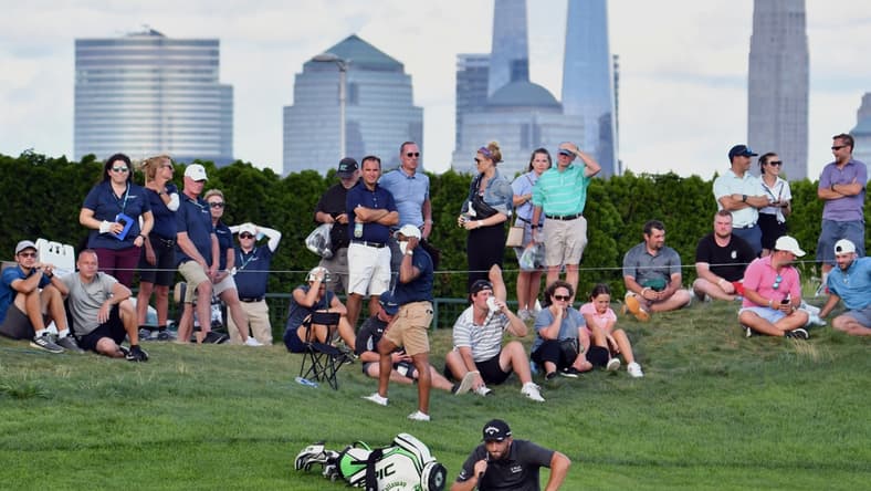 Aug 19, 2021; Jersey City, New Jersey, USA; Jon Rahm studies his putt on the 18th hole during the first round of The Northern Trust golf tournament at the Liberty National Golf Club. Mandatory Credit: Mark Konezny-USA TODAY Sports