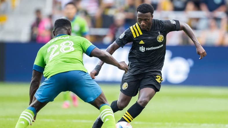 Aug 21, 2021; Columbus, Ohio, USA; Columbus Crew midfielder Derrick Etienne (22) dribbles the ball while Seattle Sounders defender Yeimar Gomez (28) defends in the first half at Lower.com Stadium. Mandatory Credit: Trevor Ruszkowski-USA TODAY Sports