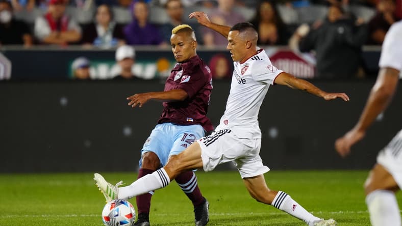 Aug 21, 2021; Commerce City, Colorado, USA; Colorado Rapids forward Michael Barrios (12) kicks the ball past Real Salt Lake defender Donny Toia (4) in the first half at Dick's Sporting Goods Park. Mandatory Credit: Ron Chenoy-USA TODAY Sports