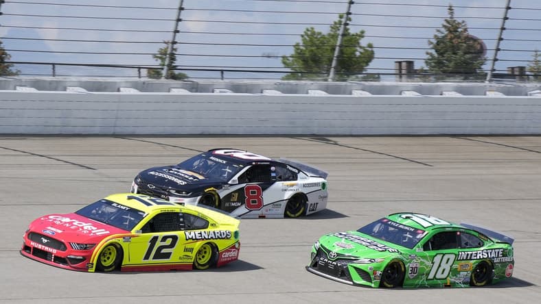 Aug 22, 2021; Brooklyn, Michigan, USA; NASCAR Cup Series driver Ryan Blaney (12), driver Tyler Reddick (8) and driver Kyle Busch (18) during the FireKeepers Casino 400 at Michigan International Speedway. Mandatory Credit: Mike Dinovo-USA TODAY Sports