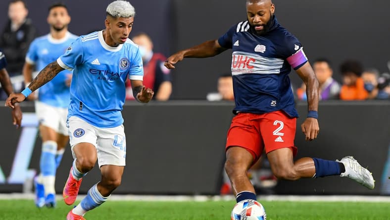 Aug 28, 2021; New York, New York, USA; New York City midfielder Santiago Rodriguez (42) defends against New England Revolution defender Andrew Farrell (2) during the first half  at Yankee Stadium. Mandatory Credit: Dennis Schneidler-USA TODAY Sports