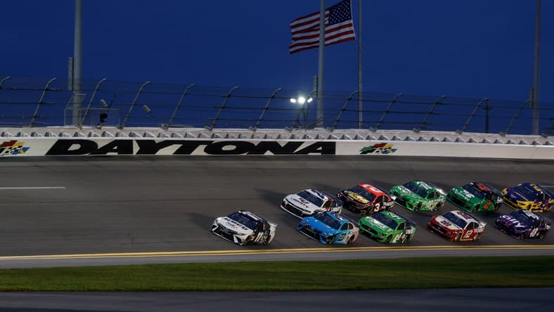 Aug 28, 2021; Daytona Beach, Florida, USA;  NASCAR Cup Series driver Denny Hamlin (11) leads through the turn for the Coke Zero 400 at Daytona International Speedway. Mandatory Credit: Nathan Ray Seebeck-USA TODAY Sports