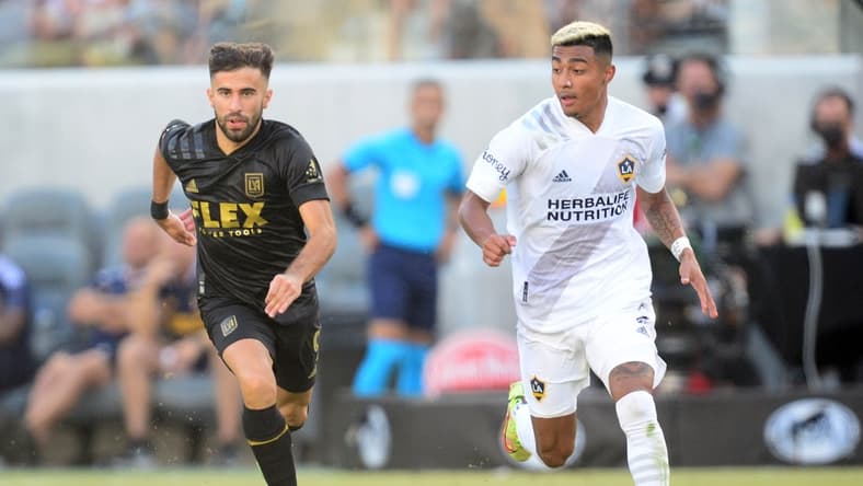 Aug 28, 2021; Los Angeles, CA, Los Angeles, CA, USA; Los Angeles FC forward Diego Rossi (9) moves the ball against Los Angeles Galaxy defender Julian Araujo (2) during the second half at Banc of California Stadium. Mandatory Credit: Gary A. Vasquez-USA TODAY Sports