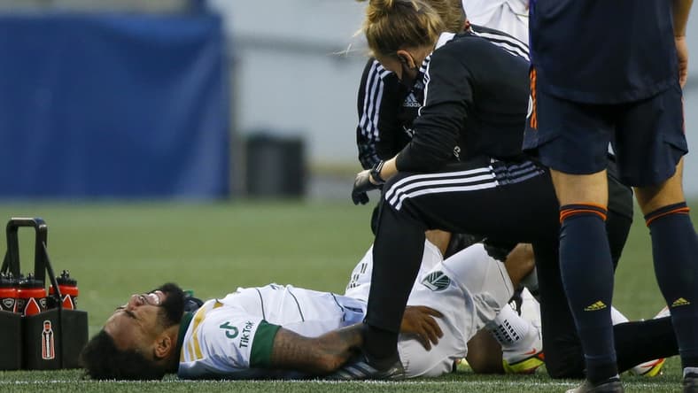 Aug 29, 2021; Seattle, Washington, USA; Portland Timbers midfielder Eryk Williamson (19) reacts after suffering a leg injury during the first half against the Seattle Sounders FC at Lumen Field. Mandatory Credit: Joe Nicholson-USA TODAY Sports