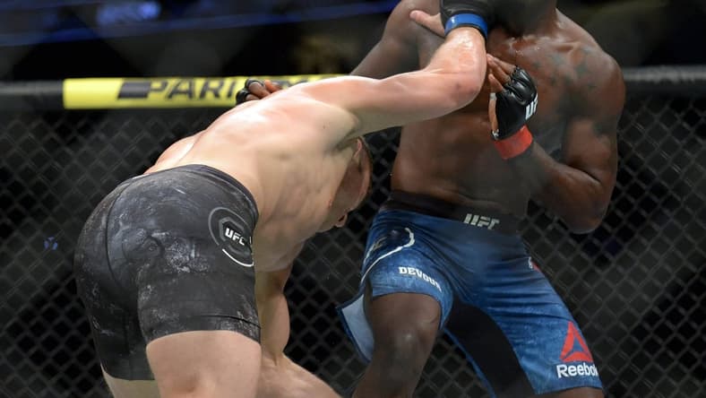August 17, 2019; Anaheim, CA, USA; Ian Heinisch moves in with a hit  as Derek Brunson defends during UFC 241 at Honda Center. Mandatory Credit: Gary A. Vasquez-USA TODAY Sports