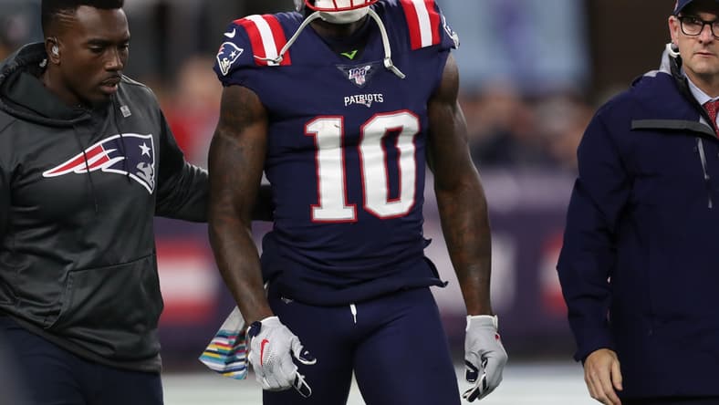 Oct 10, 2019; Foxborough, MA, USA; New England Patriots wide receiver Josh Gordon (10) is helped off of the field during the first half against the New York Giants at Gillette Stadium. Mandatory Credit: Paul Rutherford-USA TODAY Sports