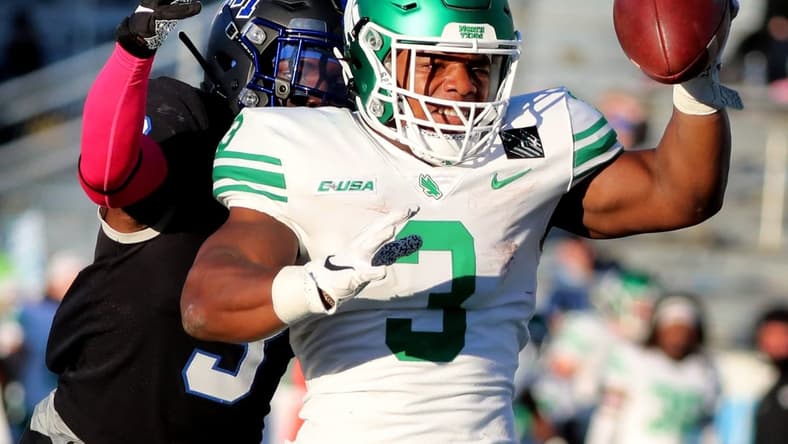 North Texas running back DeAndre Torrey (3) reaches out to make a touchdown as MTSU safety Gregory Grate Jr. (3) tackles him on Saturday, Oct. 17, 2020, during the Blackout game at MTSU.

29 Mtsu V North Texas
