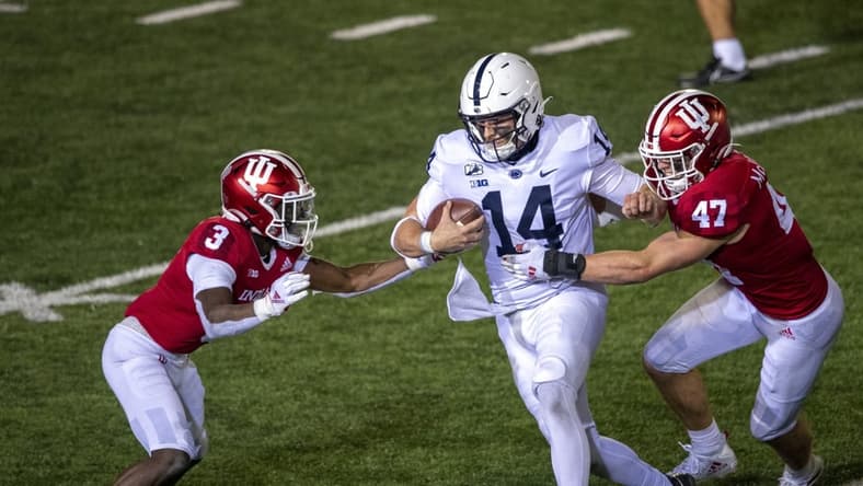 Oct 24, 2020; Bloomington, Indiana, USA;  Penn State Nittany Lions quarterback Sean Clifford (14) attempts to avoid tackle from Indiana Hoosiers linebacker Micah McFadden (47) and Indiana Hoosiers defensive back Tiawan Mullen (3)  late in the second half of the game at Memorial Stadium. The Indiana Hoosiers defeated the Penn State Nittany Lions 36 to 35.  Mandatory Credit: Marc Lebryk-USA TODAY Sports