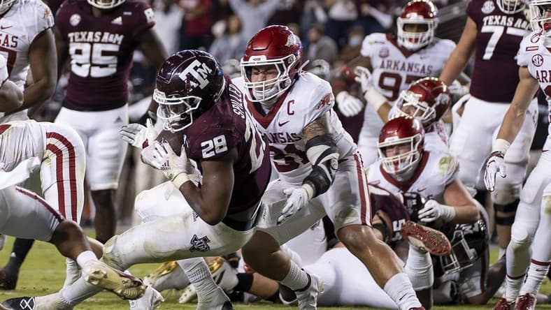 Oct 31, 2020; College Station, TX, USA; Texas A&M running back Isaiah Spiller (28) rushes for a touchdown against Arkansas linebacker Grant Morgan (31) during the second quarter of an NCAA college football game, Saturday, Oct. 31, 2020, in College Station, Texas. Mandatory Credit: Sam Craft/Pool Photo-USA TODAY Sports