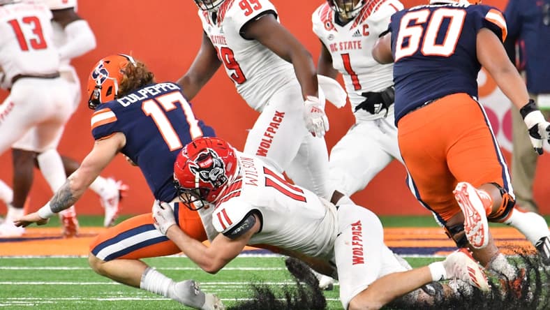 Nov 28, 2020; Syracuse, New York, USA; North Carolina State Wolfpack linebacker Payton Wilson (11) sacks Syracuse Orange quarterback Rex Culpepper (17) in the fourth quarter at the Carrier Dome. Mandatory Credit: Mark Konezny-USA TODAY Sports
