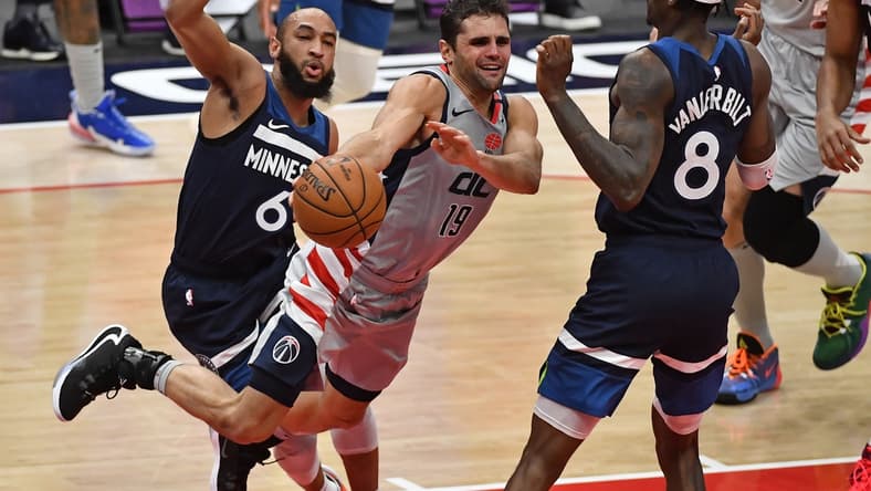 Feb 27, 2021; Washington, District of Columbia, USA; Washington Wizards guard Raul Neto (19) passes between Minnesota Timberwolves guard Jordan McLaughlin (6) and forward Jarred Vanderbilt (8) during the second quarter at Capital One Arena. Mandatory Credit: Brad Mills-USA TODAY Sports