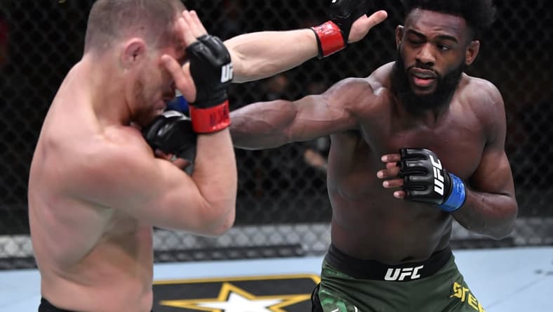 Mar 6, 2021; Las Vegas, NV, USA; Aljamain Sterling punches Petr Yan of Russia in their UFC bantamweight championship fight during the UFC 259 event at UFC APEX on March 06, 2021 in Las Vegas, Nevada.  Mandatory Credit: Jeff Bottari/Handout Photo via USA TODAY Sports