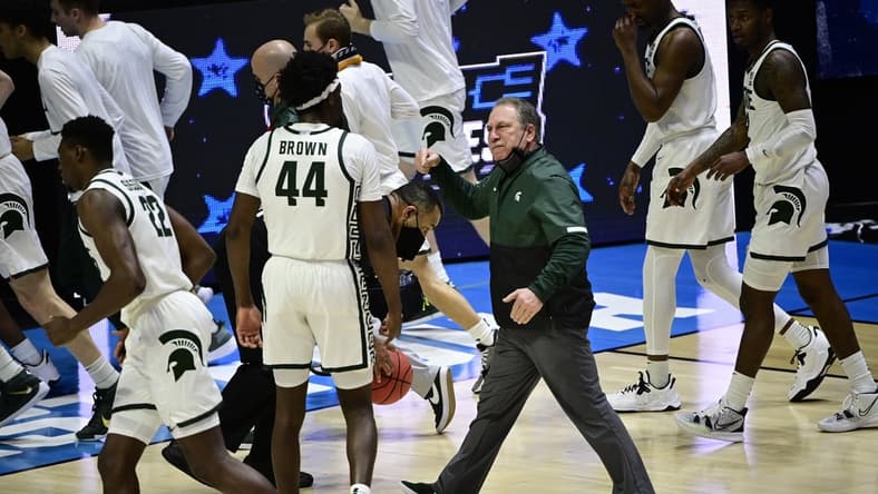 Mar 18, 2021; West Lafayette, Indiana, USA; Michigan State Spartans head coach Tom Izzo heads into the locker room as he talks with forward Gabe Brown (44) at half time during the First Four of the 2021 NCAA Tournament at Mackey Arena. Mandatory Credit: Marc Lebryk-USA TODAY Sports