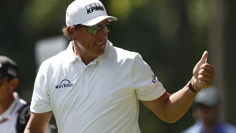 Jul 2, 2021; Detroit, Michigan, USA; Phil Mickelson gives fans a thumbs up as he walks off the 12th tee box during the second round of the Rocket Mortgage Classic golf tournament. Mandatory Credit: Raj Mehta-USA TODAY Sports