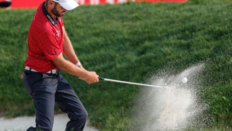 Troy Merritt hits out of 15th bunker during the second round of sudden death playoff of Rocket Mortgage Classic at the Detroit Golf Club in Detroit, Sunday, July 4, 2021.