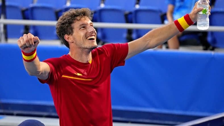 Jul 31, 2021; Tokyo, Japan; Pablo Carreno Busta (ESP) celebrates beating Novak Djokovic (SRB) in the men's tennis bronze medal match during the Tokyo 2020 Olympic Summer Games at Ariake Tennis Park. Mandatory Credit: Robert Deutsch-USA TODAY Sports