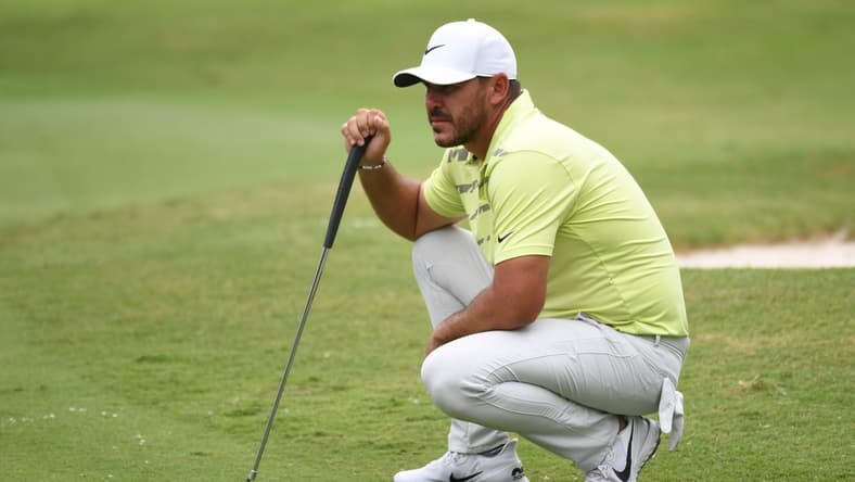 Aug 6, 2021; Memphis, Tennessee, USA; Brooks Koepka waits to putt on the fifth hole during the second round of the WGC FedEx St. Jude Invitational golf tournament at TPC Southwind. Mandatory Credit: Christopher Hanewinckel-USA TODAY Sports