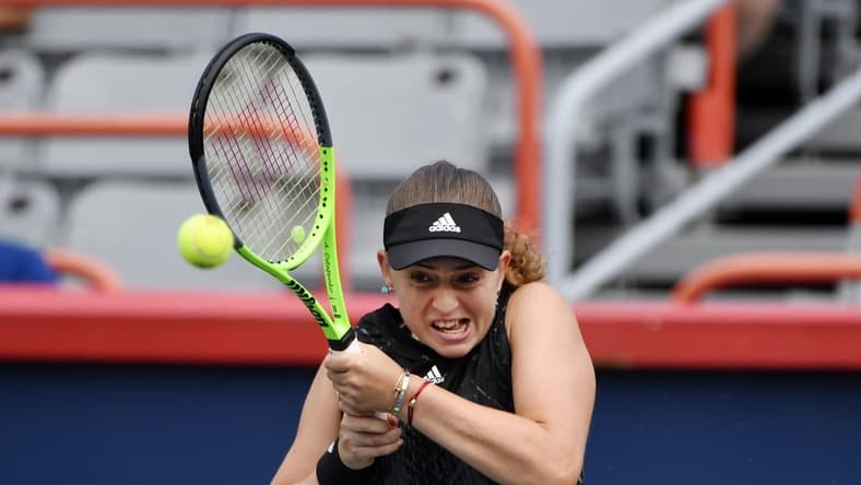 Aug 9, 2021; Montreal, Quebec, Canada; Jelena Ostapenko of Latvia hits a shot against Katerina Siniakova of the Czech Republic (not pictured) during first round play at Stade IGA. Mandatory Credit: Eric Bolte-USA TODAY Sports