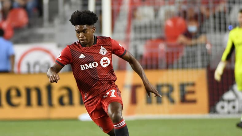 Aug 14, 2021; Toronto, Ontario, CAN;  Toronto FC midfielder Ralph Priso-Mbongue (97) advances the ball upfield against New England Revolution in the first half at BMO Field. Mandatory Credit: Dan Hamilton-USA TODAY Sports