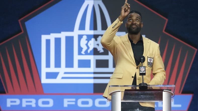 Aug 8, 2021; Canton, Ohio, USA; Detroit Lions former receiver and inductee Calvin Johnson gestures as he delivers his acceptance speech during the Class of 2021 NFL Hall of Fame induction ceremony at Tom Benson Hall of Fame Stadium. Mandatory Credit: Charles LeClaire-USA TODAY Sports
