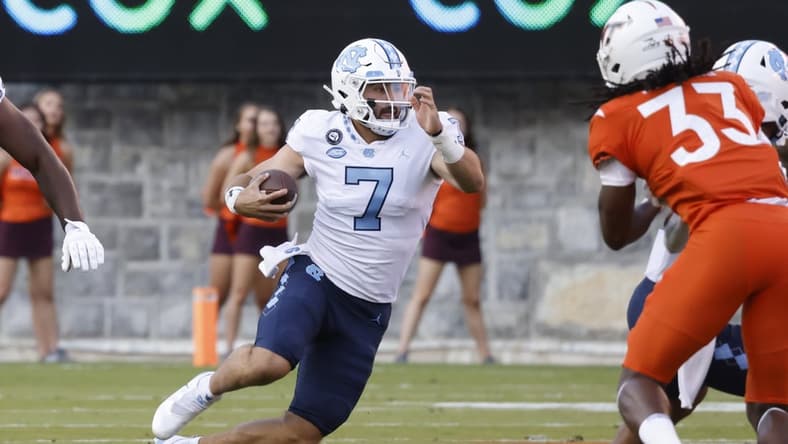 Sep 3, 2021; Blacksburg, Virginia, USA; North Carolina Tar Heels quarterback Sam Howell (7) runs the ball during the first quarter at Lane Stadium. Mandatory Credit: Reinhold Matay-USA TODAY Sports