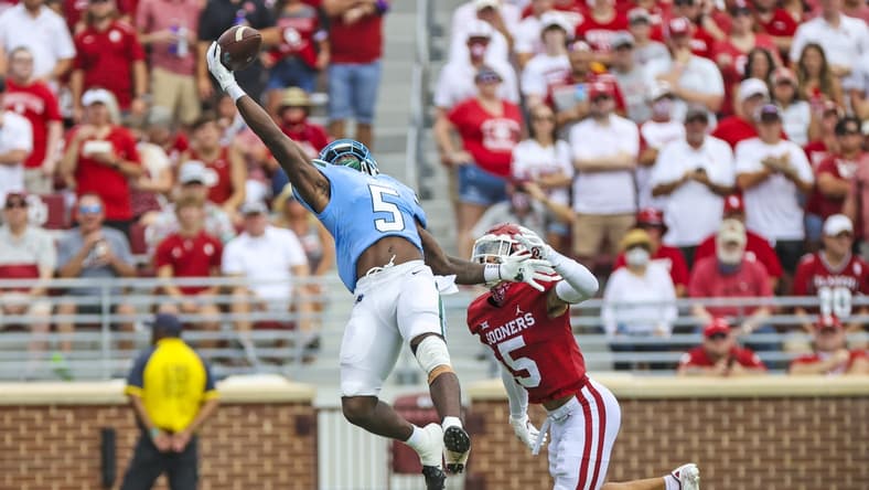 Sep 4, 2021; Norman, Oklahoma, USA; Tulane Green Wave running back Ygenio Booker (5) makes a leaping catch in front of Oklahoma Sooners defensive back Billy Bowman (5) during the first quarter at Gaylord Family-Oklahoma Memorial Stadium. Mandatory Credit: Kevin Jairaj-USA TODAY Sports