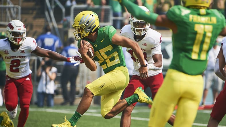 Sep 4, 2021; Eugene, Oregon, USA;  Oregon Ducks running back Travis Dye (26) scores a touchdown during the first half against the Fresno State Bulldogs at Autzen Stadium. Mandatory Credit: Troy Wayrynen-USA TODAY Sports