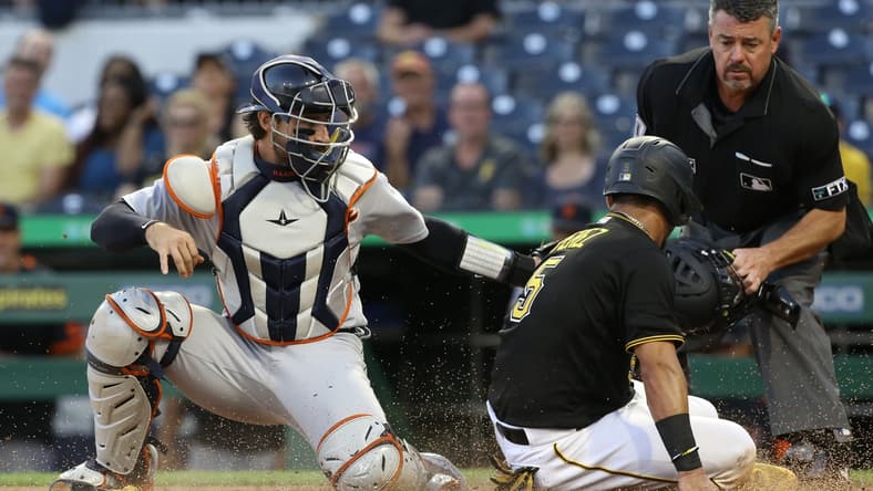 Sep 7, 2021; Pittsburgh, Pennsylvania, USA; Detroit Tigers catcher Eric Haase (13) tags Pittsburgh Pirates catcher Michael Perez (5) out at home plate attempting to score during the second inning at PNC Park. Mandatory Credit: Charles LeClaire-USA TODAY Sports