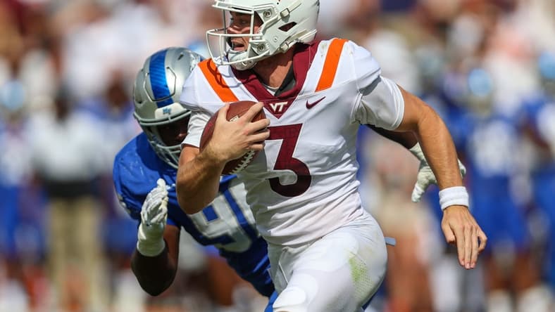 Sep 11, 2021; Blacksburg, Virginia, USA;  Virginia Tech Hokies quarterback Braxton Burmeister (3) runs the ball against Middle Tennessee Blue Raiders defensive lineman Zaylin Wood (96) during the second quarter at Lane Stadium. Mandatory Credit: Ryan Hunt-USA TODAY Sports