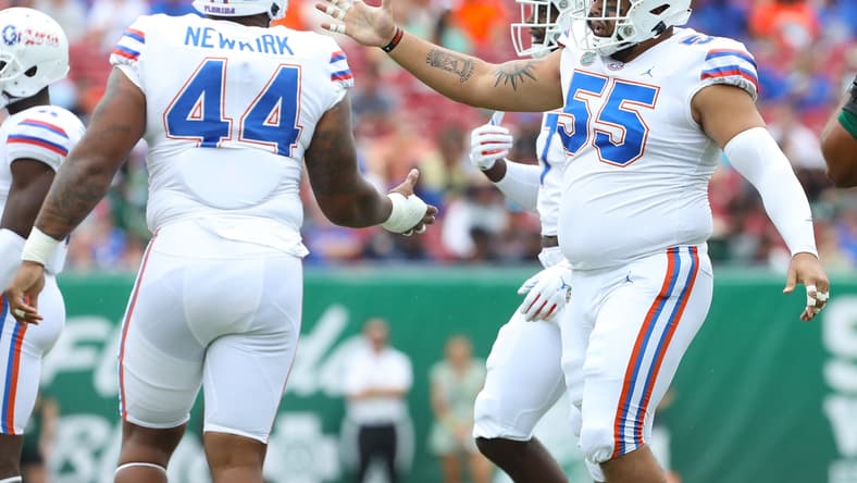 Florida Gators defensive lineman Antonio Valentino (55) congratulates Florida Gators defensive lineman Daquan Newkirk (44) after a big stop during the second game of the season against the USF Bulls at Raymond James Stadium, in Tampa Fla. Sept. 11, 2021.
Flgai 09112021 Ufvs Usf Action32