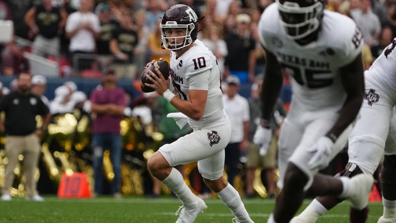 Sep 11, 2021; Denver, Colorado, USA; Texas A&M Aggies quarterback Zach Calzada (10) looks to pass in the second quarter against the Colorado Buffaloes at Empower Field at Mile High. Mandatory Credit: Ron Chenoy-USA TODAY Sports