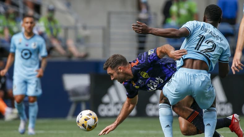 Sep 11, 2021; Seattle, Washington, USA; Seattle Sounders FC forward Will Bruin (17) draws a foul against Minnesota United FC defender Bakaye Dibassy (12) during the first half at CenturyLink Field. Mandatory Credit: Joe Nicholson-USA TODAY Sports