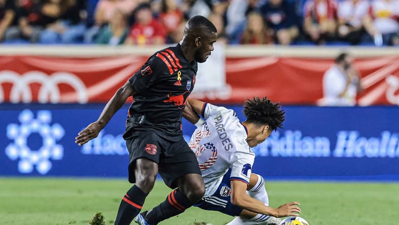 Sep 11, 2021; Harrison, New Jersey, USA; New York Red Bulls midfielder Dru Yearwood (16) battles for the ball against D.C. United midfielder Kevin Paredes (30) during the first half at Red Bull Arena. Mandatory Credit: Vincent Carchietta-USA TODAY Sports