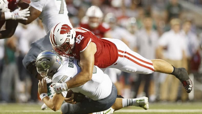 Sep 11, 2021; Madison, Wisconsin, USA; Wisconsin Badgers defensive end Matt Henningsen (92) sacks Eastern Michigan Eagles quarterback Ben Bryant (8) during the second quarter at Camp Randall Stadium. Mandatory Credit: Jeff Hanisch-USA TODAY Sports