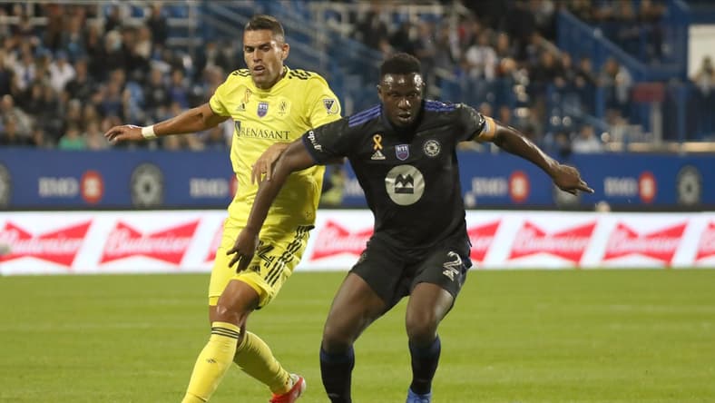 Sep 11, 2021; Montreal, Quebec, CAN; CF Montreal midfielder Victor Wanyama (2) plays the ball against Nashville SC forward Daniel Rios (14) during the first half at Stade Saputo. Mandatory Credit: Jean-Yves Ahern-USA TODAY Sports
