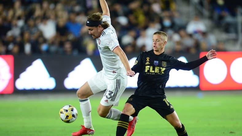 Sep 12, 2021; Los Angeles, California, USA; Real Salt Lake midfielder Nick Besler (13) moves the ball against Los Angeles FC midfielder Bryce Duke (19) during the first half at Banc of California Stadium. Mandatory Credit: Gary A. Vasquez-USA TODAY Sports