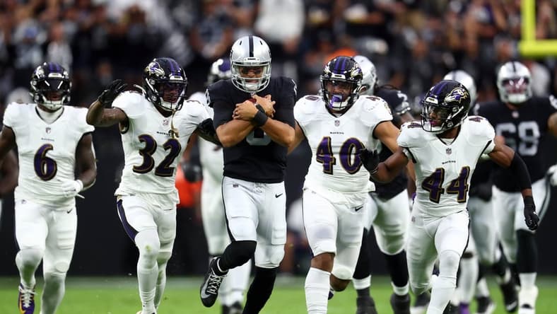 Sep 13, 2021; Paradise, Nevada, USA; Las Vegas Raiders quarterback Marcus Mariota (8) runs the ball ahead of Baltimore Ravens linebacker Patrick Queen (6) defensive back DeShon Elliott (32) linebacker Malik Harrison (40) and cornerback Marlon Humphrey (44) during the first half at Allegiant Stadium. Mandatory Credit: Mark J. Rebilas-USA TODAY Sports