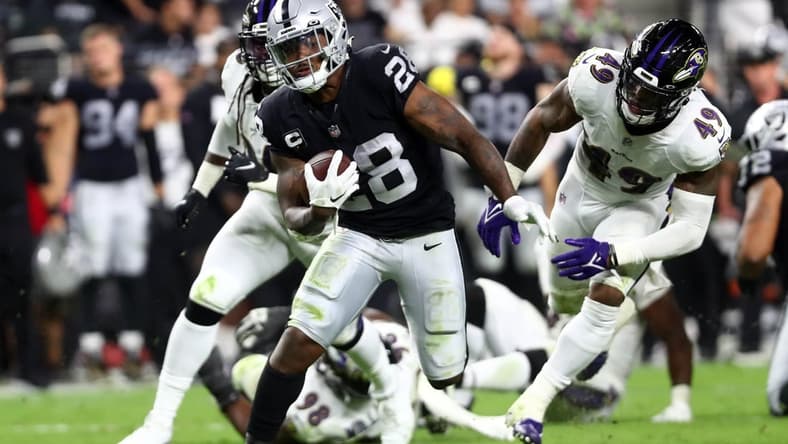 Sep 13, 2021; Paradise, Nevada, USA; Las Vegas Raiders running back Josh Jacobs (28) runs the ball against the Baltimore Ravens during the second half at Allegiant Stadium. Mandatory Credit: Mark J. Rebilas-USA TODAY Sports
