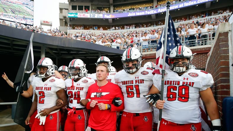 Sep 11, 2021; Oxford, Mississippi, USA; Austin Peay Governors head coach Scotty Walden (middle), offensive linemen Garrett Bell (57), wide receiver Trey Goodman (24), offensive linemen Colby McKee (51) and offensive linemen Michael Treadwell (69) prepare to run out of the tunnel before their game against the Mississippi Rebels at Vaught-Hemingway Stadium. Mandatory Credit: Petre Thomas-USA TODAY Sports