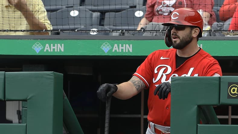Sep 16, 2021; Pittsburgh, Pennsylvania, USA; Cincinnati Reds third baseman Mike Moustakas (9) looks on from the dugout before batting against the Pittsburgh Pirates during the first inning at PNC Park. Mandatory Credit: Charles LeClaire-USA TODAY Sports