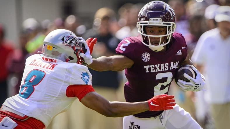 Sep 18, 2021; College Station, Texas, USA; Texas A&M Aggies wide receiver Chase Lane (2) stiff arms New Mexico Lobos cornerback Donte Martin (8) during the first half at Kyle Field. Mandatory Credit: Jerome Miron-USA TODAY Sports